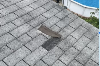 Broken tab on a shingled roof