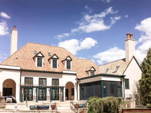 A house with a new cedar shake roof.