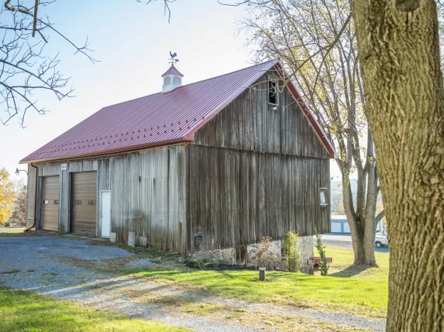 A barn with a metal corrugated metal roof